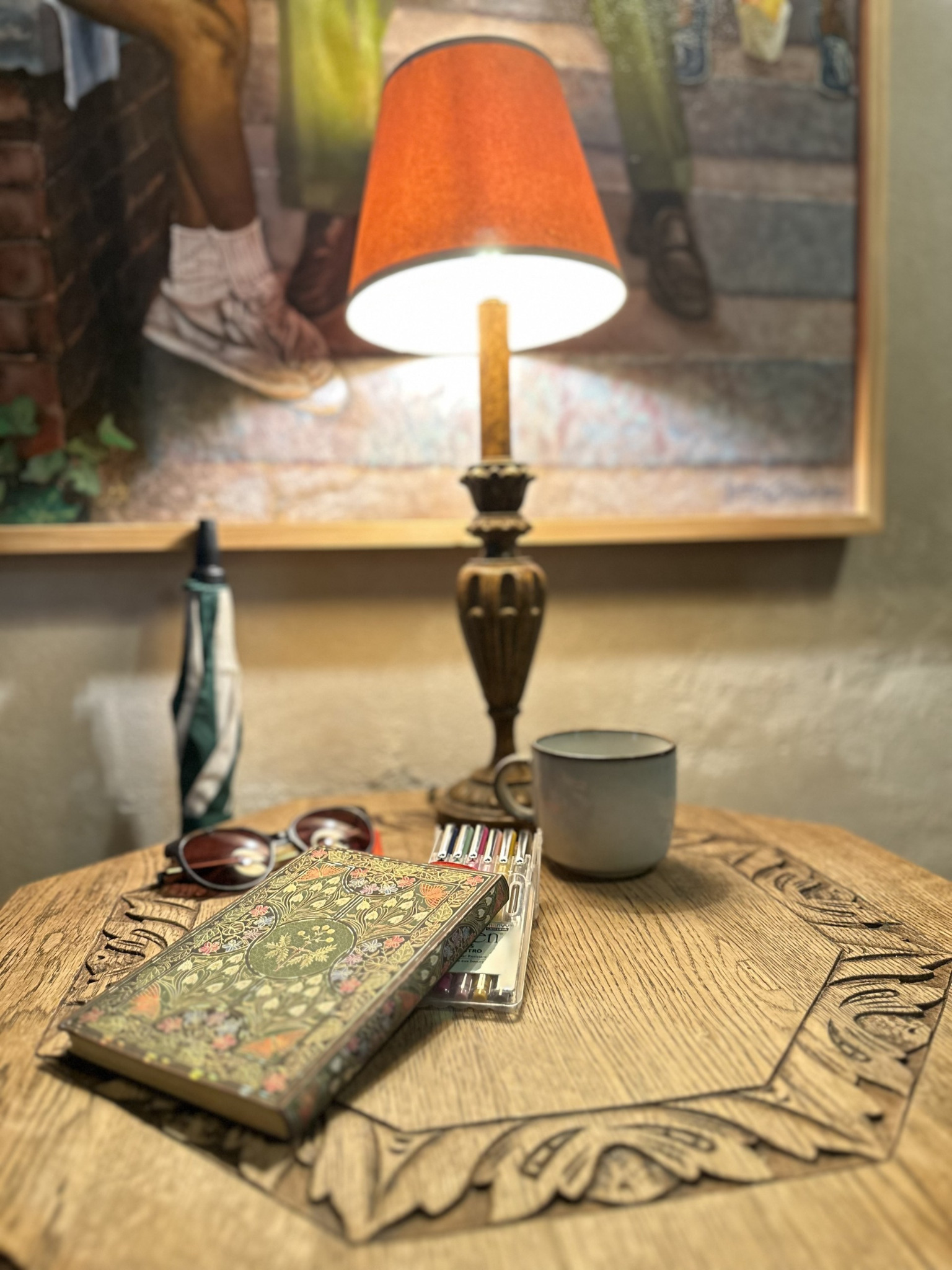 Notebook, mug, and painting materials in a café